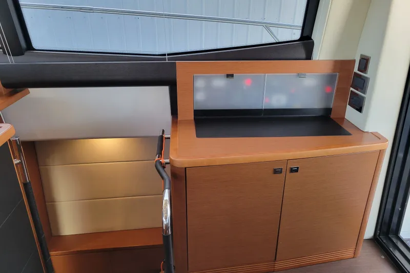 Slide: The Image of Interior of a 2017 Prestige 500 yacht featuring sleek wooden cabinetry and modern design elements. - 35