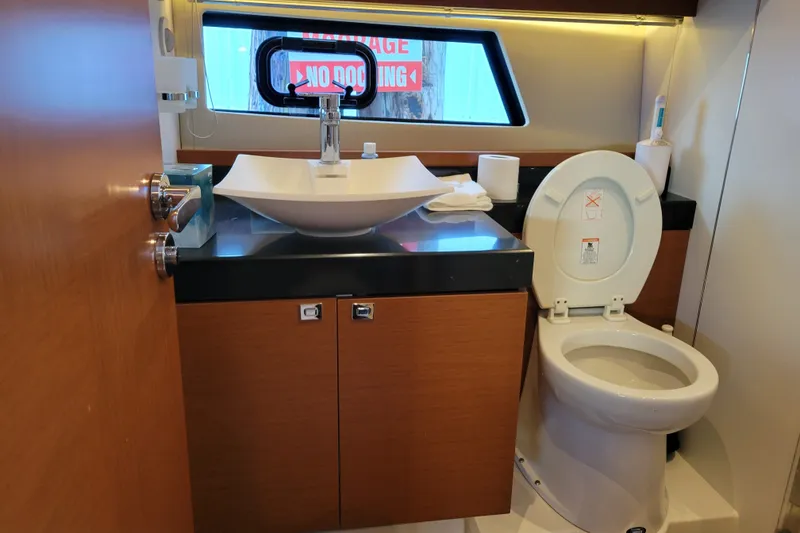 Slide: The Image of Luxurious bathroom in a 2017 Prestige 500 yacht, featuring modern sink and toilet. - 32