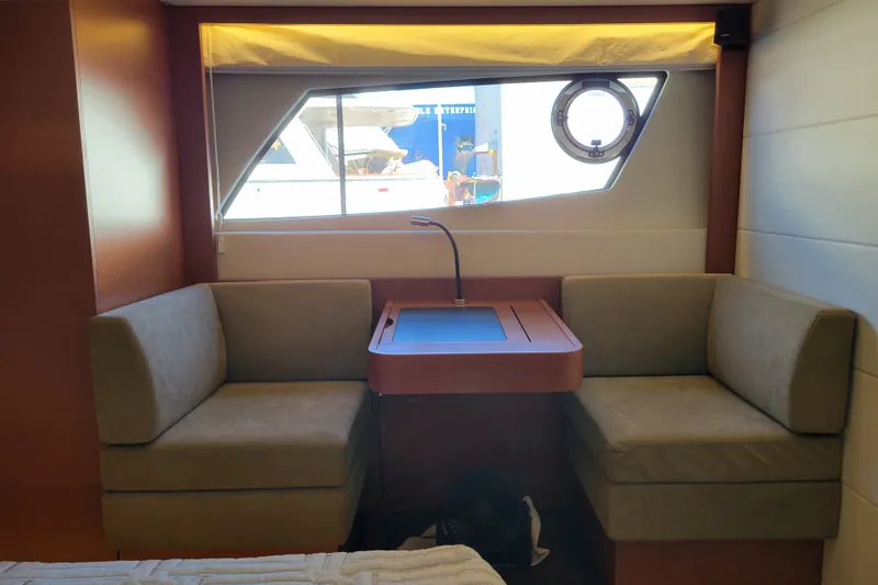 Slide: The Image of Interior of a 2017 Prestige 500 yacht with cozy seating and a window view. - 37