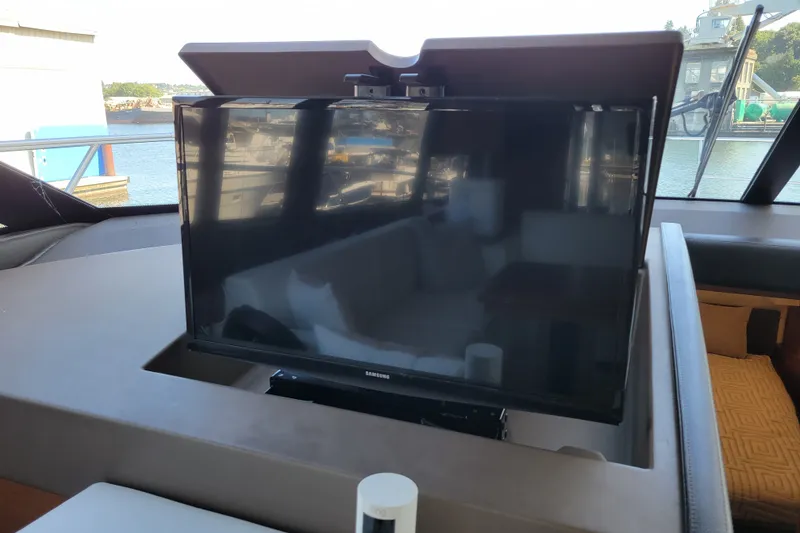 Slide: The Image of Flat-screen TV on a 2017 Prestige 500 yacht, with marina view in the background. - 28