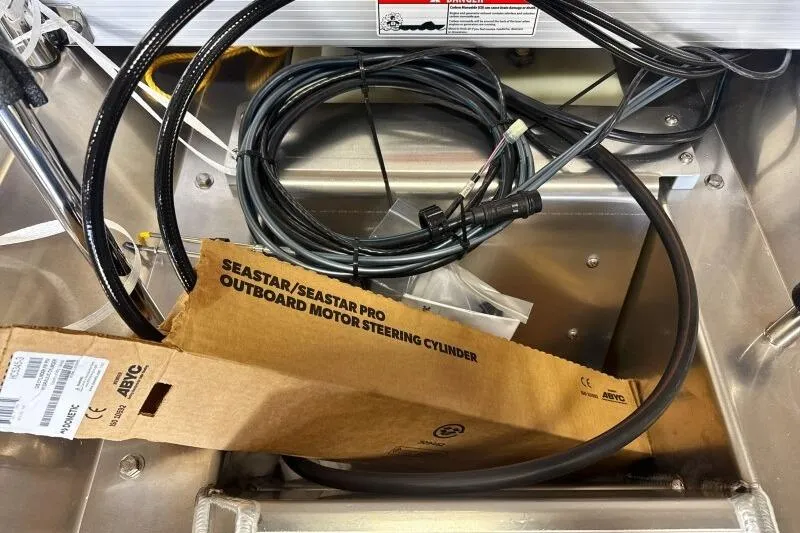Slide: The Image of Box and cables inside a 2026 Bennington 23 SX L-Bench boat compartment. - 9