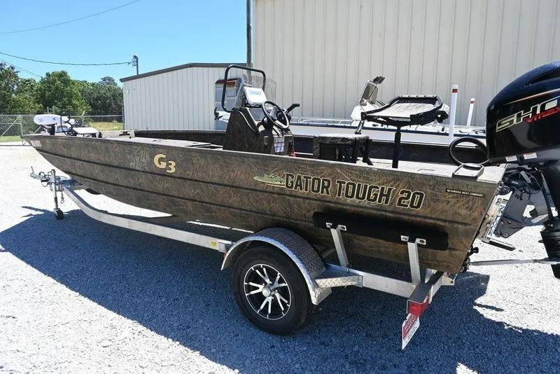 Slide: The Image of 2025 G3 Gator Tough 20 CC boat on trailer, parked outdoors. - 11