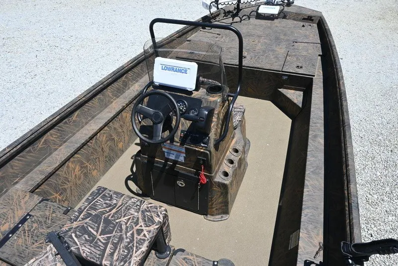 Slide: The Image of 2025 G3 Gator Tough 20 CC boat interior with camo design and Lowrance electronics. - 2