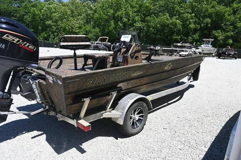 Slide: The Image of 2025 G3 Gator Tough 20 CC boat on trailer, parked outdoors. - 4