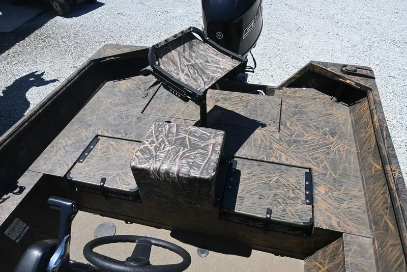 Slide: The Image of 2025 G3 Gator Tough 20 CC boat interior with camouflage seating and steering wheel. - 6