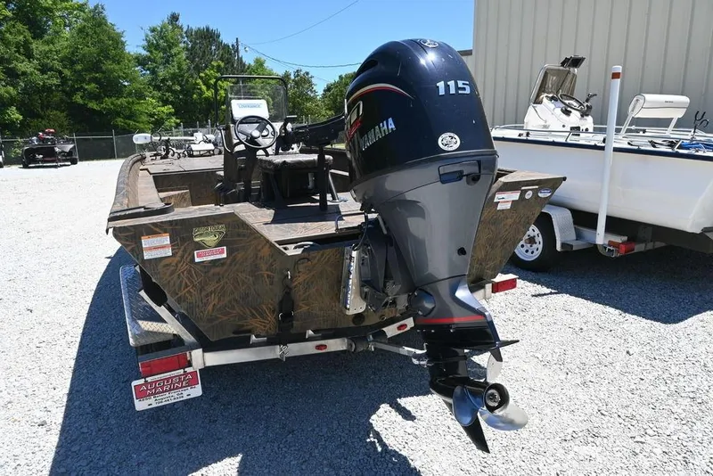 Slide: The Image of 2025 G3 Gator Tough 20 CC boat with Yamaha 115 engine, parked outdoors. - 9