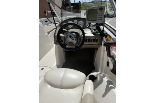 Slide: The Image of 2006 Nitro 288 Sport boat cockpit with steering wheel and navigation system. - 2