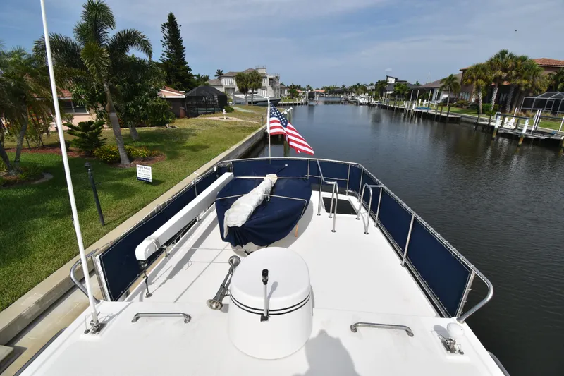 Slide: The Image of Nordic Tug 37 (2007) on a canal, featuring deck view with American flag. - 10