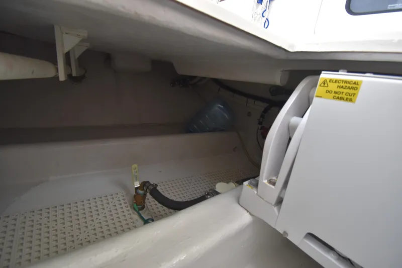 Slide: The Image of Interior view of a 2007 Nordic Tug 37 engine compartment with electrical hazard warning. - 12