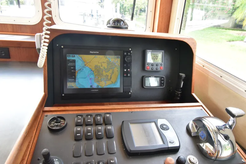 Slide: The Image of Control panel of a 2007 Nordic Tug 37 with navigation and communication equipment. - 16