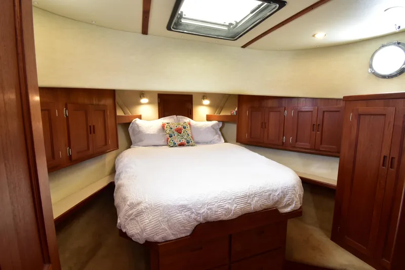 Slide: The Image of Cozy cabin interior of 2007 Nordic Tug 37 with wood cabinetry and plush bedding. - 19