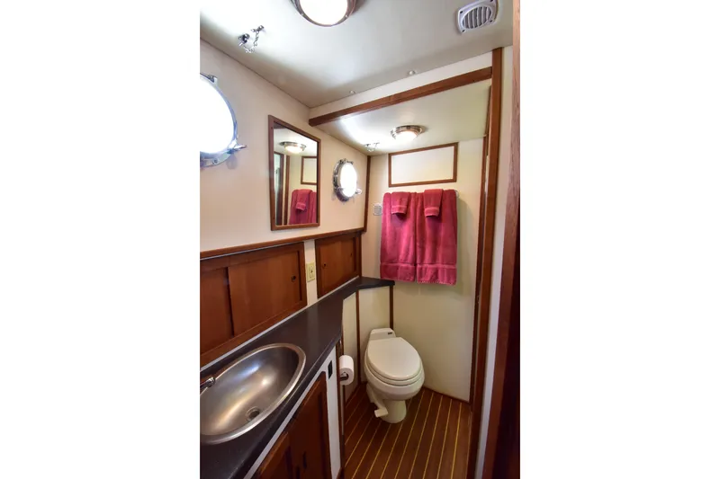 Slide: The Image of Bathroom interior of 2007 Nordic Tug 37 with sink, toilet, and wooden cabinetry. - 20