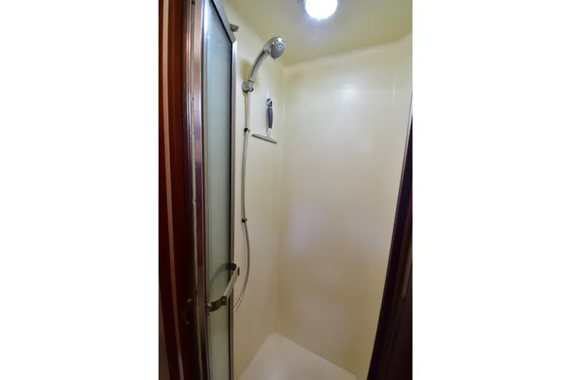 Slide: The Image of Shower area in 2007 Nordic Tug 37 boat with glass door and overhead light. - 21