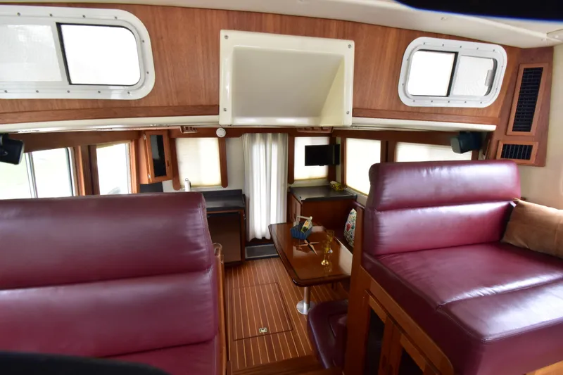 Slide: The Image of Interior of 2007 Nordic Tug 37 with red leather seating and wooden accents. - 25