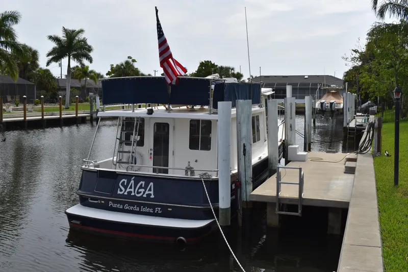 Slide: The Image of Nordic Tug 37 (2007) docked in Punta Gorda Isles, FL, with American flag. - 3