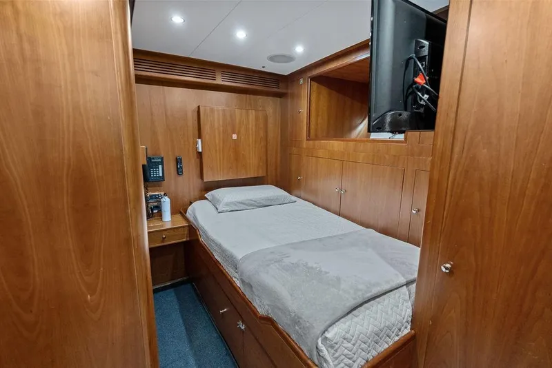 Slide: The Image of Luxurious 2008 Benetti Classic yacht cabin with wooden interior and cozy single bed. - 100