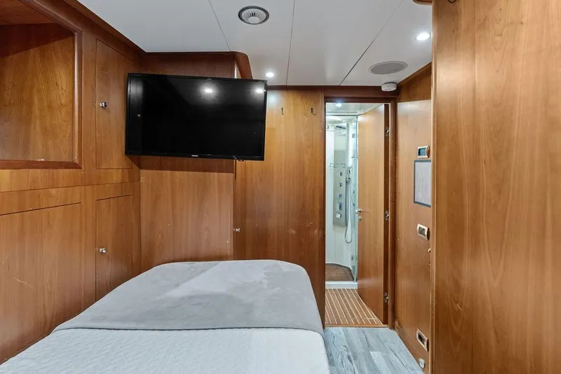 Slide: The Image of Luxurious 2008 Benetti Classic yacht cabin with wood paneling and modern amenities. - 101