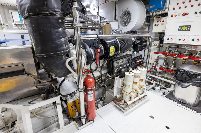 Slide: The Image of Engine room of a 2008 Benetti Classic yacht, showcasing machinery and control panels. - 104