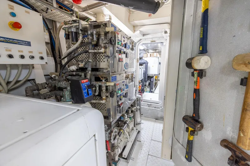 Slide: The Image of Engine room of a 2008 Benetti Classic yacht, showcasing machinery and tools. - 105