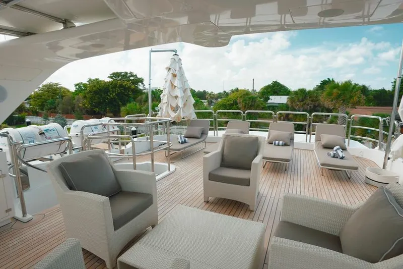 Slide: The Image of Luxurious deck of a 2008 Benetti Classic yacht with elegant seating and scenic views. - 11