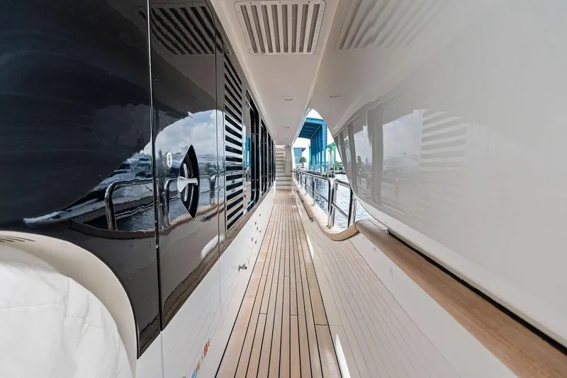 Slide: The Image of Side deck of a 2008 Benetti Classic yacht with sleek design and wooden flooring. - 14