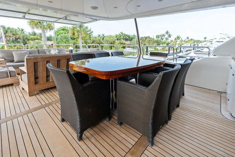 Slide: The Image of Luxury outdoor dining area on 2008 Benetti Classic yacht with wicker chairs and wooden table. - 18