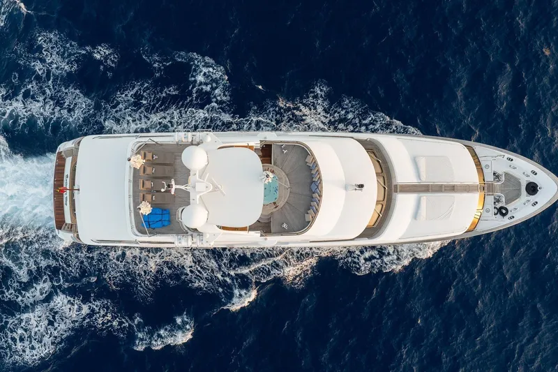 Slide: The Image of Aerial view of 2008 Benetti Classic yacht cruising through deep blue ocean waters. - 2