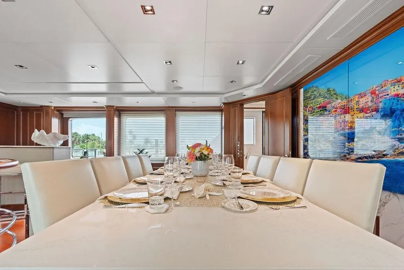 Slide: The Image of Luxurious dining area on a 2008 Benetti Classic yacht, featuring elegant decor and scenic artwork. - 28