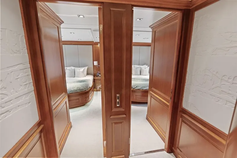 Slide: The Image of Luxurious bedroom interior on 2008 Benetti Classic yacht with wooden accents and plush bedding. - 31