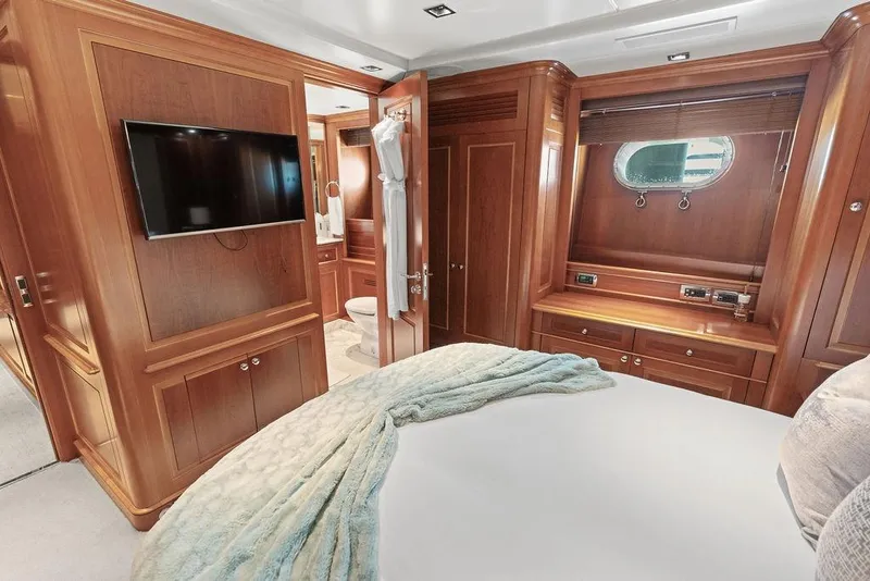Slide: The Image of Luxurious 2008 Benetti Classic yacht bedroom with wood paneling and modern amenities. - 34