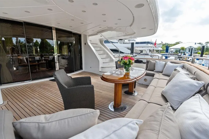 Slide: The Image of Luxurious 2008 Benetti Classic yacht deck with elegant seating and floral centerpiece. - 5