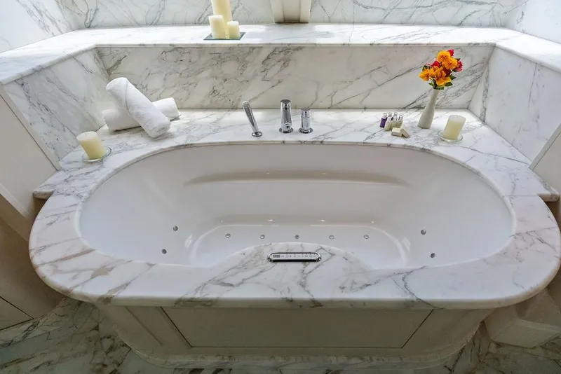 Slide: The Image of Luxurious marble bathtub on a 2008 Benetti Classic yacht, adorned with candles and flowers. - 51