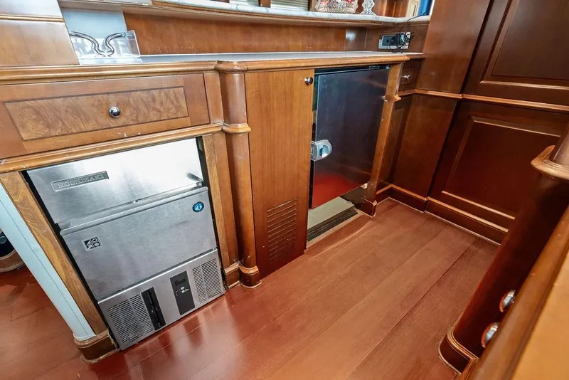 Slide: The Image of Luxurious wooden interior of a 2008 Benetti Classic yacht with built-in appliances. - 65