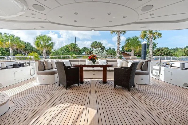 Slide: The Image of Luxurious 2008 Benetti Classic yacht deck with elegant seating and tropical backdrop. - 8