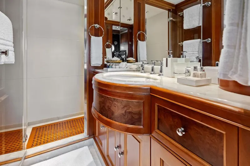 Slide: The Image of Luxurious bathroom in a 2008 Benetti Classic yacht, featuring elegant wood cabinetry and modern fixtures. - 84