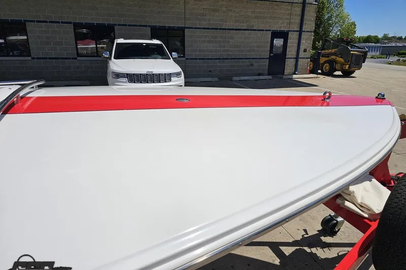 Slide: The Image of 1997 Donzi 18 Classic boat with red and white design on a trailer. - 12
