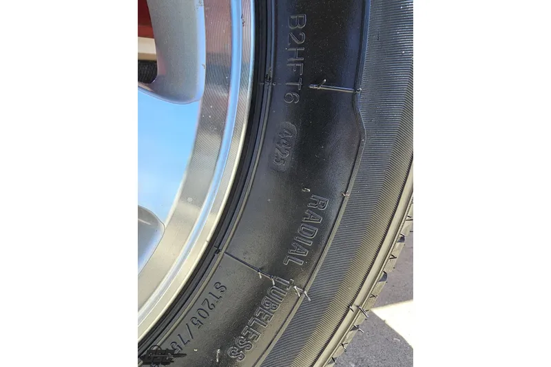 Slide: The Image of Close-up of a radial tubeless tire on a 1997 Donzi 18 Classic boat trailer. - 18