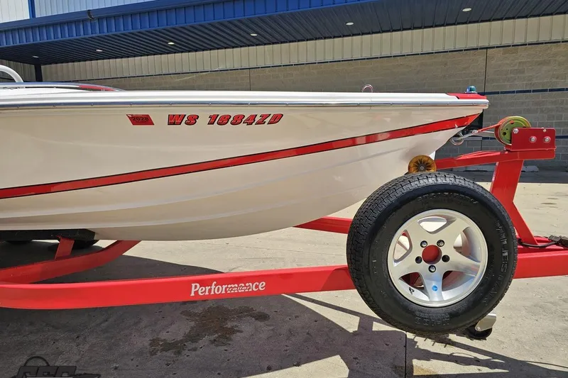 Slide: The Image of 1997 Donzi 18 Classic boat on red trailer, side view with registration number visible. - 22