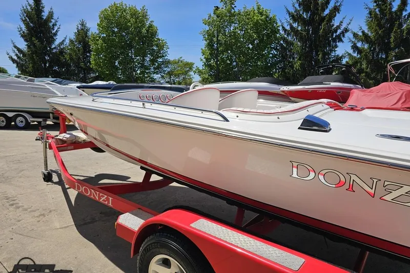 Slide: The Image of 1997 Donzi 18 Classic boat on a red trailer, parked outdoors. - 36