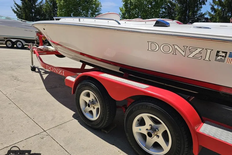 Slide: The Image of 1997 Donzi 18 Classic boat on red trailer, parked outdoors. - 38