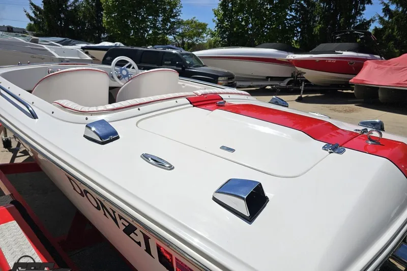 Slide: The Image of 1997 Donzi 18 Classic boat with red and white design, parked outdoors. - 39