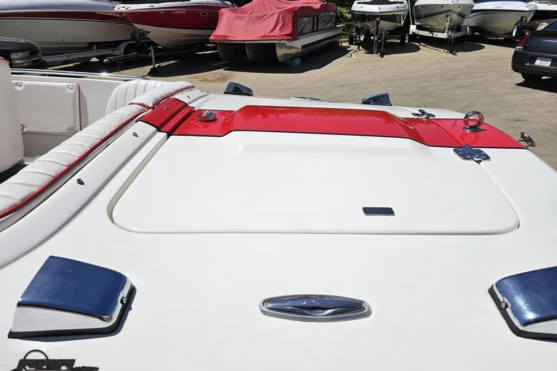 Slide: The Image of 1997 Donzi 18 Classic boat with red and white deck, parked among other boats. - 40