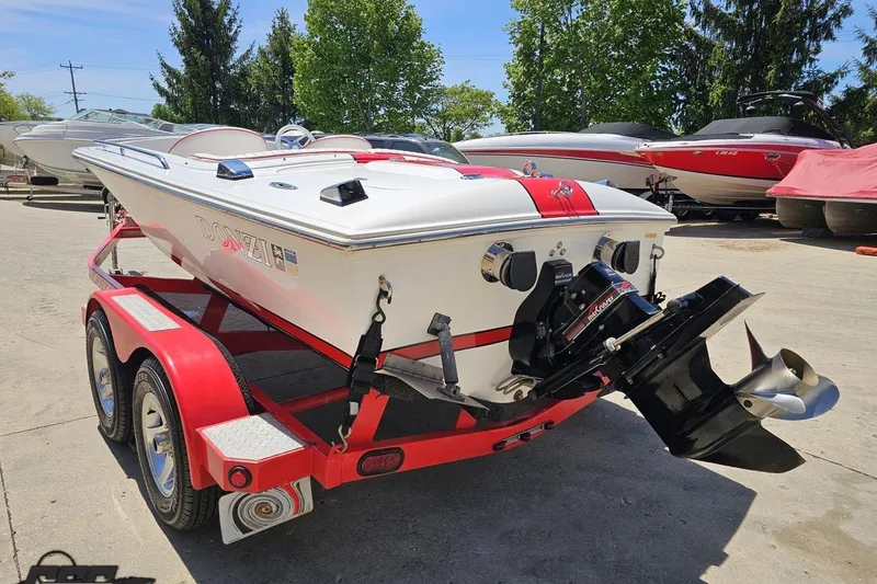 Slide: The Image of 1997 Donzi 18 Classic boat on a red trailer, parked outdoors. - 43