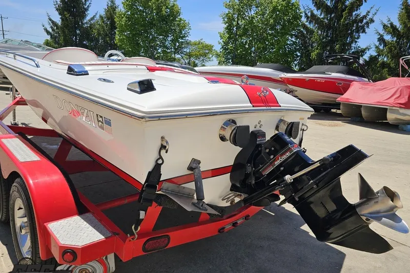 Slide: The Image of 1997 Donzi 18 Classic boat on red trailer, showcasing sleek design and powerful engine. - 44
