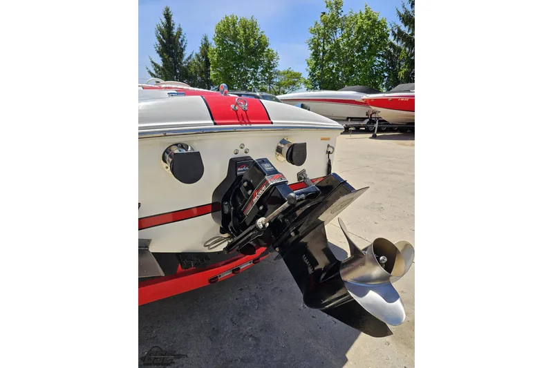 Slide: The Image of 1997 Donzi 18 Classic boat with red and white design, featuring a powerful outboard motor. - 45