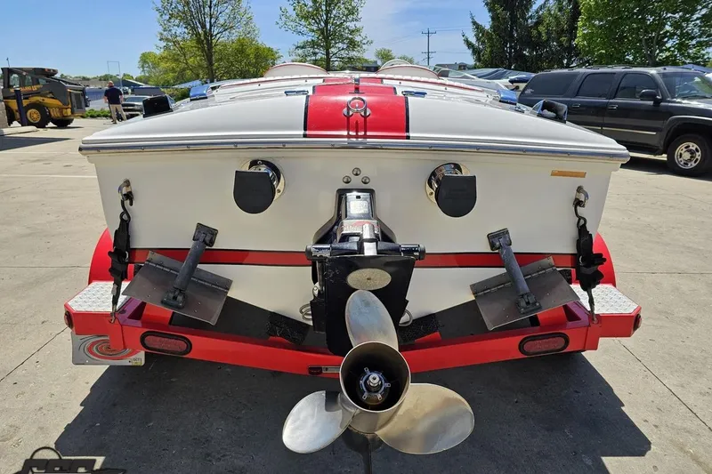 Slide: The Image of Rear view of a 1997 Donzi 18 Classic boat on a trailer, showcasing propeller and trim tabs. - 46