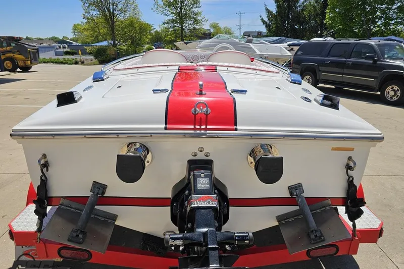 Slide: The Image of 1997 Donzi 18 Classic boat with red stripe, parked outdoors on a sunny day. - 48