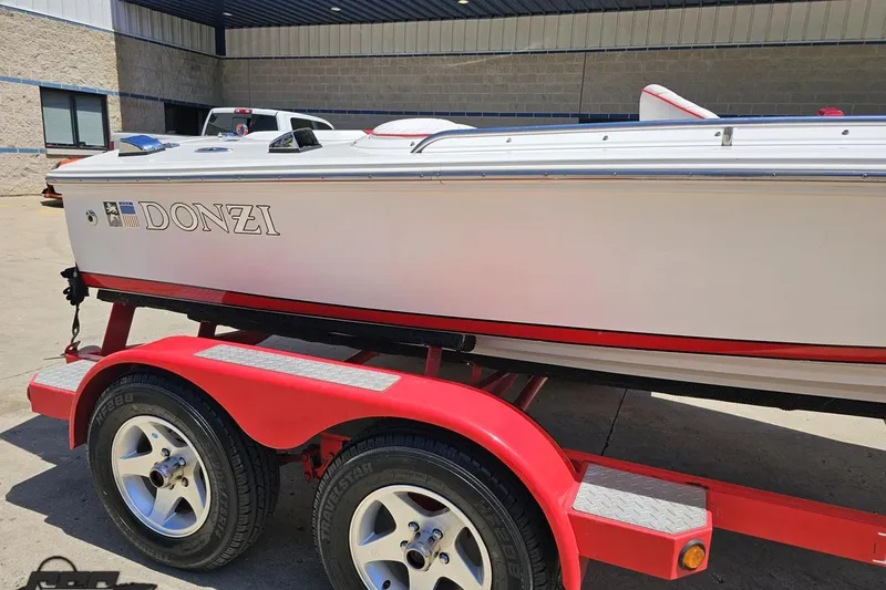 Slide: The Image of 1997 Donzi 18 Classic boat on red trailer, parked outdoors. - 5