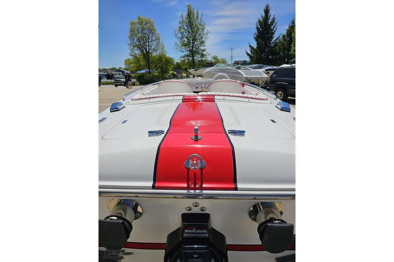 Slide: The Image of 1997 Donzi 18 Classic boat with red and white design, parked outdoors. - 50
