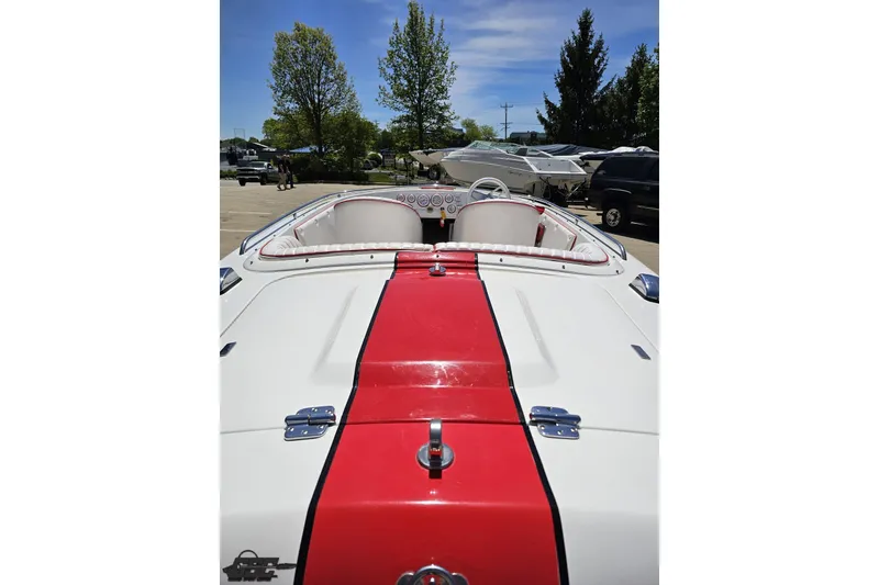 Slide: The Image of 1997 Donzi 18 Classic boat with red stripe, parked outdoors on a sunny day. - 51